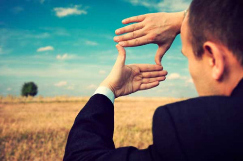 man looking through hands